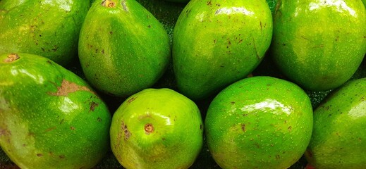 Fresh bunch of green avocados or Alpukat or Palta background. Ready sold in supermarket