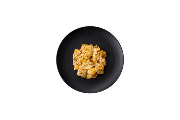 Delicious soft white feta cheese with salt, spices and herbs on a dark concrete background
