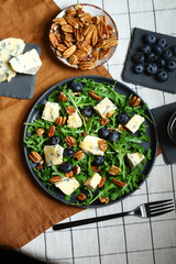 Blue cheese with honey, arugula and blueberries. Healthy salad with arugula and dorblu.