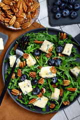 Blue cheese with honey, arugula and blueberries. Healthy salad with arugula and dorblu.