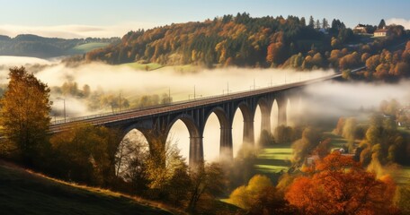 The Enchanting View of a Railway Bridge in Autumn, Amidst a Village's Foggy Dawn