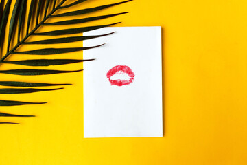 Lipstick kiss on white blank, minimal concept, yellow background