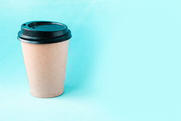 takeaway coffee cup on blue background. Copy space for the text. Minimal concept