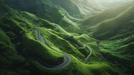 Aerial view of winding roads through lush green hills - obrazy, fototapety, plakaty