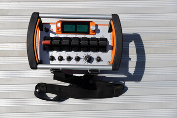 A remote control concrete pump truck is sitting on top of a metal surface