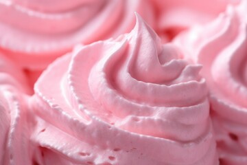 Close up of delicate pink whipped cream with a smooth, swirled texture