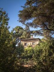A bastion tower between trees inside the Alhambra palace complex in Granada, Andalusia, Spain