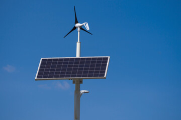 Solar panel and a small wind turbine installed on a street light pole. Perfect for illustrating renewable energy, sustainability, and urban infrastructure.