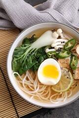 Bowl of vegetarian ramen on table, top view
