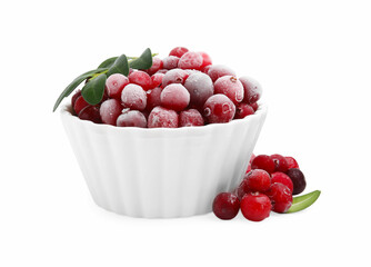 Frozen red cranberries in bowl and green leaves isolated on white
