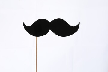 Fake paper mustache party prop against white background