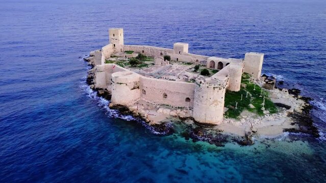 Experience the beauty of Kizkalesi Castle in Mersin, Turkey, captured by a drone at sunset. Explore the stunning aerial views showcasing the enchanting Maiden's Castle Immerse in the allure of Mersin