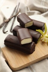Glazed vanilla curd cheese bars on table, closeup