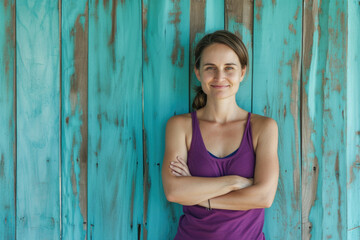 Fototapeta premium Woman standing in front of wooden wall. Suitable for various uses