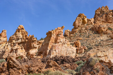 Fototapeta na wymiar Piedras Amarillas rock formation in El Teide National Park on Tenerife. Orange volcanic cliffs close up.