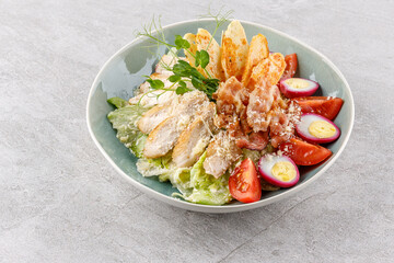 Caesar salad with chicken and bacon on a stone background studio food photo 2