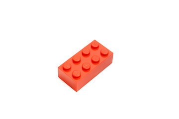 Obraz premium Single red lego plastic brick isolated on white background
