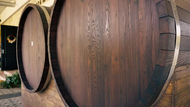 close-up of large wooden wine barrels in the production of alcoholic beverages wine storage