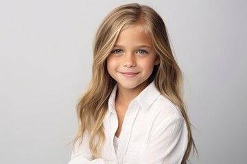 Portrait of a cute little girl with long blond hair, studio shot