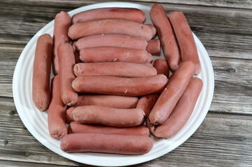 boiled hot dog,  dish consisting of a grilled, steamed, or boiled sausage served in the slit of a...