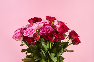 Bouquet of roses on pink background. Valentines day, 8 march or mother day floral gift.