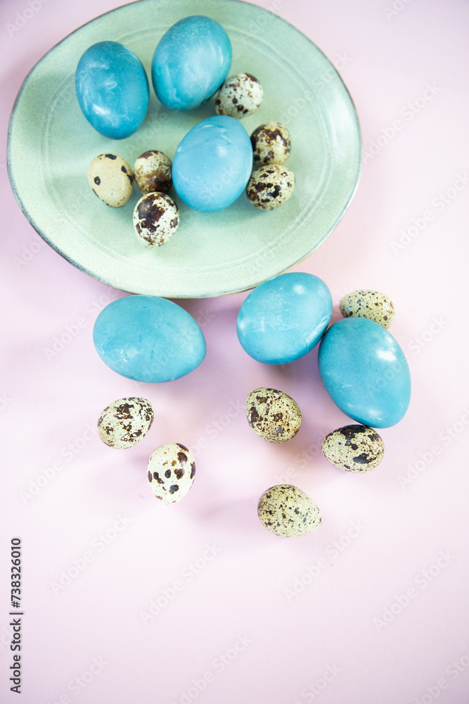 Wall mural blue Easter eggs on light pink background