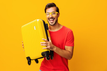 Vacation man journey background studio traveler trip yellow flight suitcase guy travel happy...