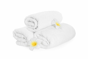 Obraz na płótnie Canvas Rolled terry towels and plumeria flowers isolated on white