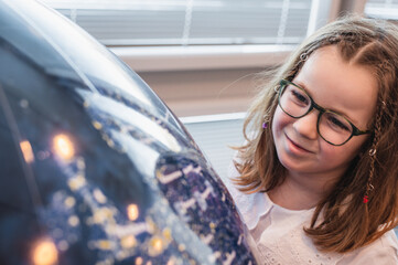 a child watches and learns a globe in a planetarium close-up. High quality photo