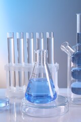 Laboratory analysis. Different glassware on table against light background