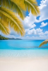 Palm leaves over a tropical beach with clear blue water and a blue sky with few clouds