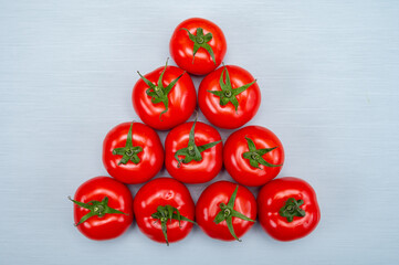 Food triangle, Red ripe tasty Dutch tomatoes, vegetables background top view close up copy space