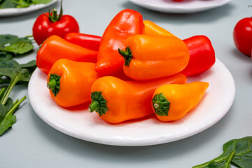 Fresh red, orange, and yellow sweet bell paprika close up