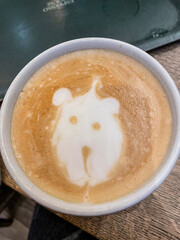 Bear face silhouette made with cream on an espresso coffee