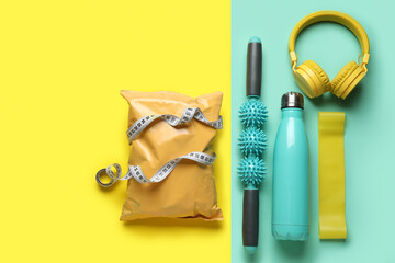 Set of sports equipment and healthy snack on color background