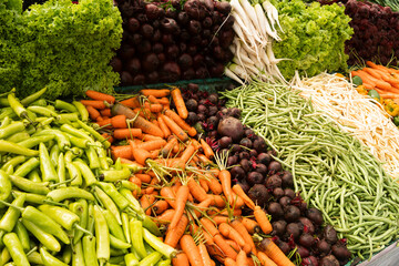 Fresh different vegetables, green bean, beetroot, pepper, carrot on market as background. Organic texture. Local food and vegetables. Agriculture. Close up.