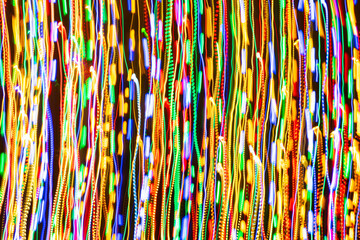Psychedelic abstract long exposure motion colour lights. Light trails, leaks and glowing electricity. Music visualisation abstraction background. Christmas holiday festive lights.