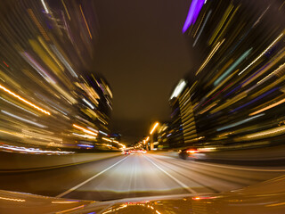 Long exposure fast speedy city drive at roads and highway. City roads in downtown and glittering...
