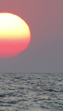 the sun is sinking into the sea. possible to accelerate the image stream. Vertical video for social media.	
