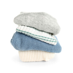 Stack of new different sweaters on white background