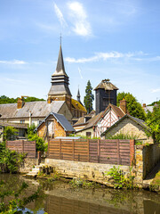 Fototapeta na wymiar Medieval church in houses in Broglie, Normandy