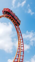 roller coaster high in the summer sky at theme park most excited fun and joyful playing machine
