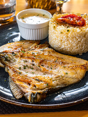 Fish and rice with a butter sauce at a French restaurant