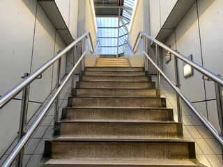 Stairs leading upwards into the main concourse of a railway station from an underground car park