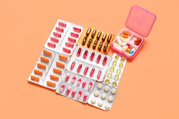 Assortment of pills on color background