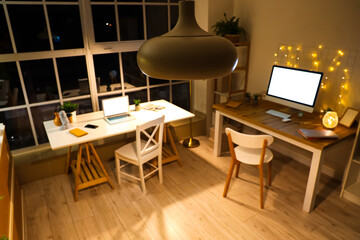 Hanging lamp in modern office at night, closeup