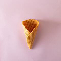 Ice cream cone on purple pastel background. Minimal summer concept. Flat lay.