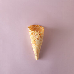 Ice cream cone on purple pastel background. Minimal summer concept. Flat lay.