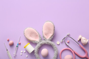 Bunny ears with Easter eggs and medical supplies on lilac background