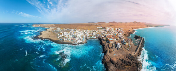 Panoramic aerial view of the famous El Cotillo beach, in Fuerteventura island: View of the secluded beaches on the coast of the Atlantic Ocean, a paradise for surfing  tourists, in the Canary Islands.